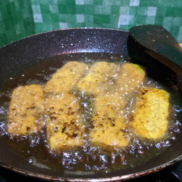 Panaskan secukupnya minyak, goreng tempe bumbu kuning hingga golden brown.