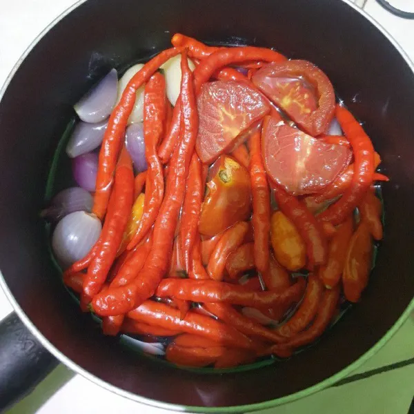 Rebus cabe merah, cabe rawit, bawang merah, bawang putih dan 1 buah tomat. Rebus selama 10 menit, angkat dan diamkan suhu ruang