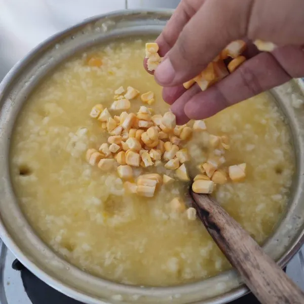 Masukkan jagung manis ketika nasi sudah mulai lembek. Masak sampai jagung matang.