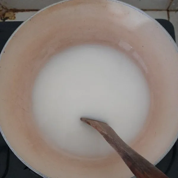 Tuang air kelapa dan susu kental manis ke dalam panci, masak dengan api kecil hingga mendidih.