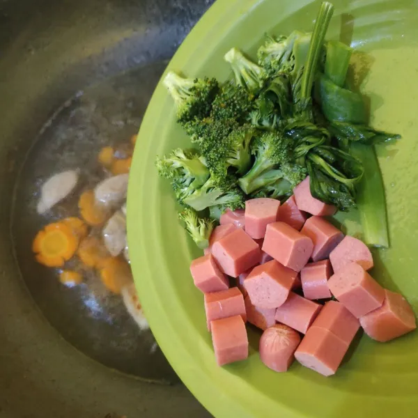 Masukkan sosis, brokoli, daun bawang dan seledri.