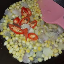 Masukkan jagung, aduk rata tuang air, kemudian masukkan cabai merah.