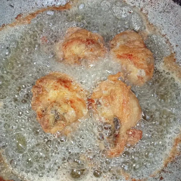 Panaskan minyak secukupnya lalu masukkan ayam dan goreng hingga ayam matang kuning keemasan (gunakan api sedang supaya ayam matang merata).