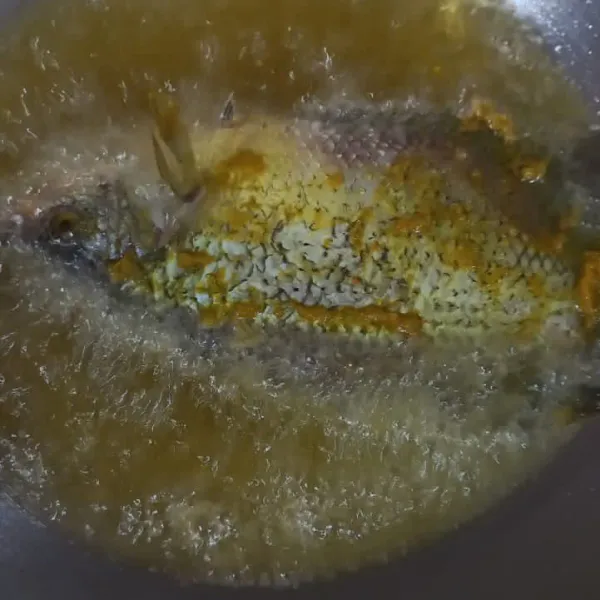 Panaskan minyak goreng, lalu goreng ikan hingga setengah matang. Tips: tambahkan 1 ruas jahe ke dalam minyak ketika menggoreng ikan, supaya tidak lengket dan mudah dibalik.