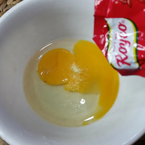 Pecahkan telur dan tambahkan lada bubuk dan kaldu ayam bubuk, lalu kocok lepas.