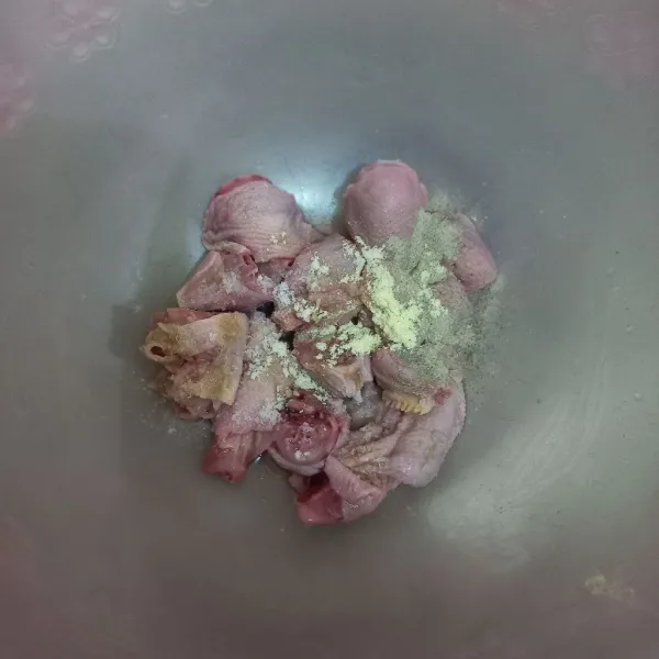 Lumuri potongan kepala ayam dengan garam, kaldu jamur, merica bubuk dan bawang putih bubuk, aduk rata.