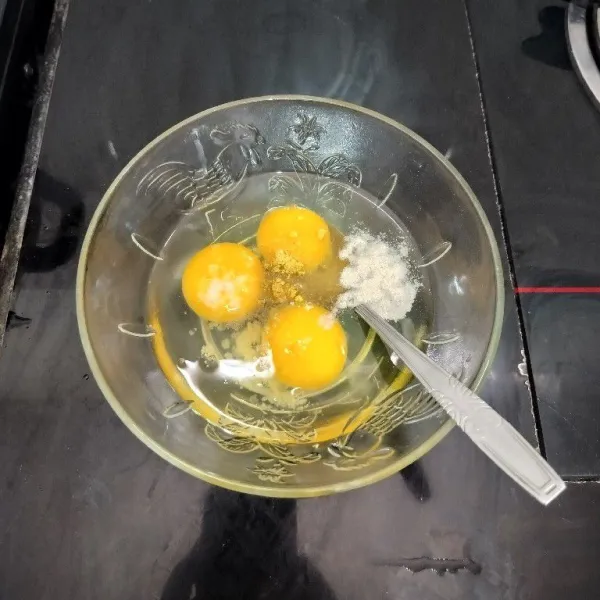 Pecahkan telur dalam mangkuk. Lalu tambahkan merica bubuk, kaldu bubuk dan garam. Kocok hingga tercampur rata.