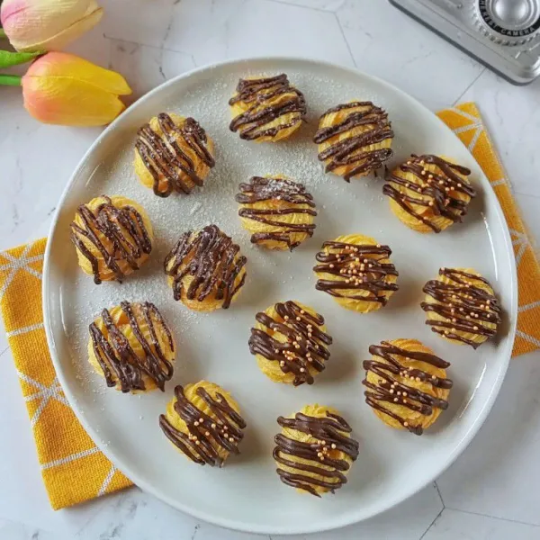 Setelah soes dingin segera aplikasi dengan topping coklat diatasnya dan tambahkan gula atau sprinkel sebagai hiasan. Sajikan.