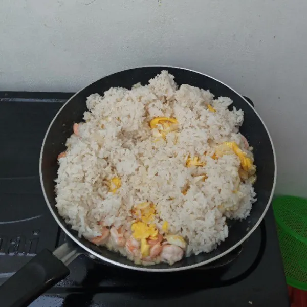 Masukkan nasi dan telur orak arik, aduk rata.