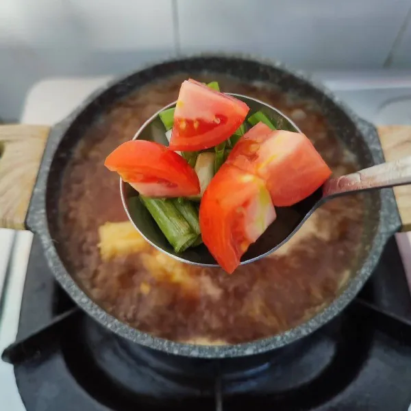 Masukkan potongan tomat dan daun bawang sesaat sebelum kompor dimatikan. Sajikan selagi hangat.