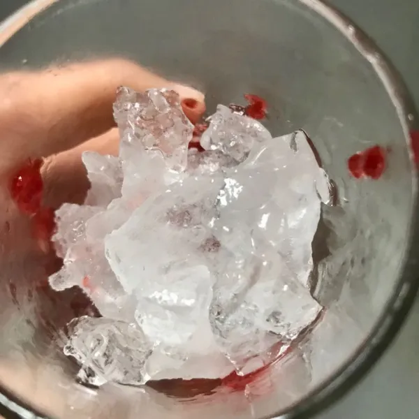 Masukkan stroberi dan es batu secara selang seling pada gelas saji.