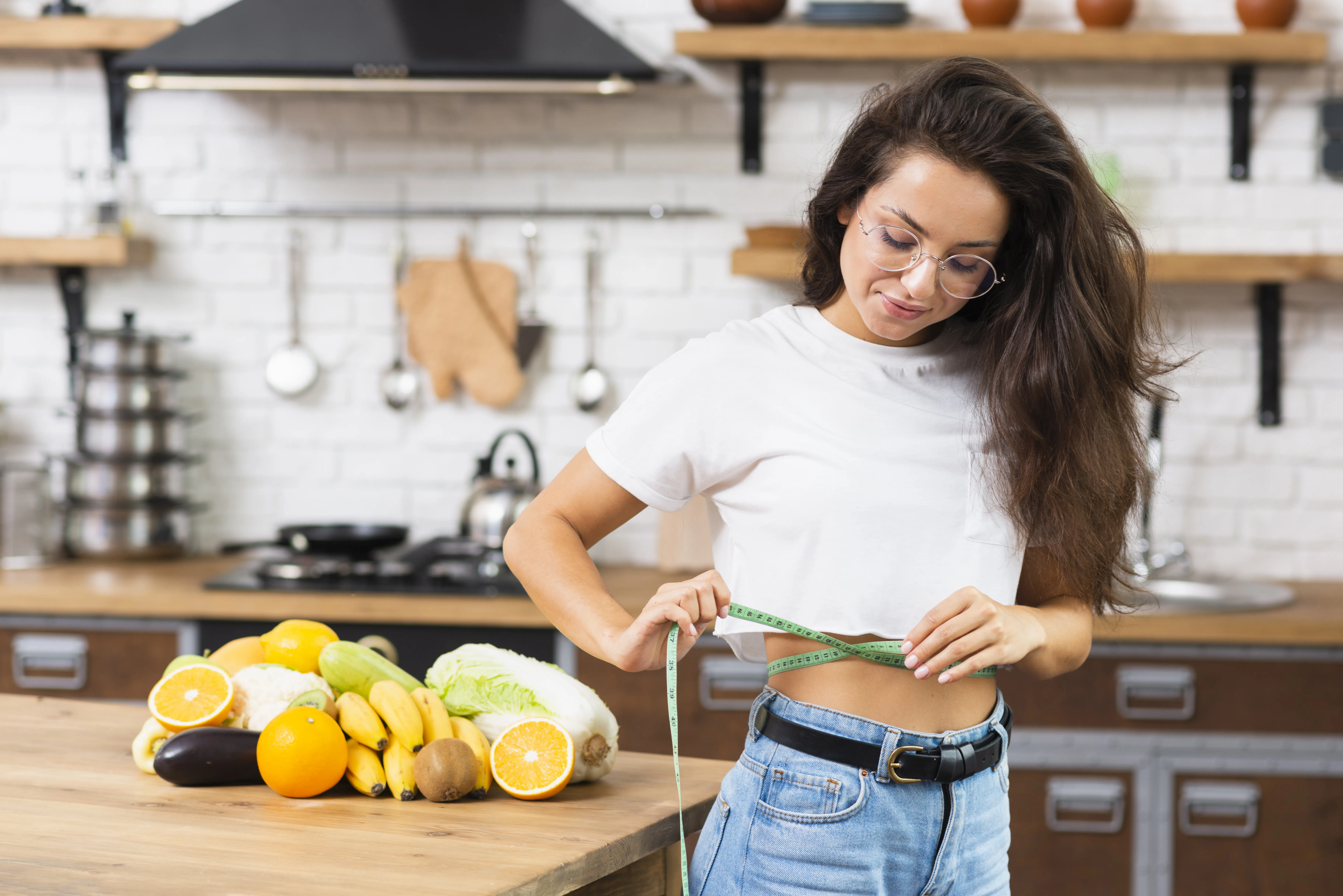 Seorang wanita sedang mengukur lingkar perut setelah detox