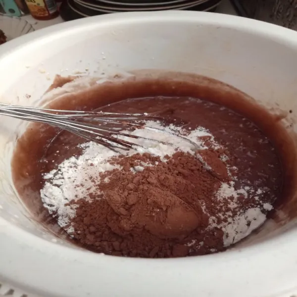 Tambahkan tepung terigu dan coklat bubuk yang sudah diayak, aduk hingga rata.