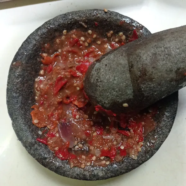 Lalu ulek bawang merah, bawang putih, cabe, tomat, terasi, garam, dan gula sampai halus, terakhir kucuri dengan air jeruk nipis, tes rasa.