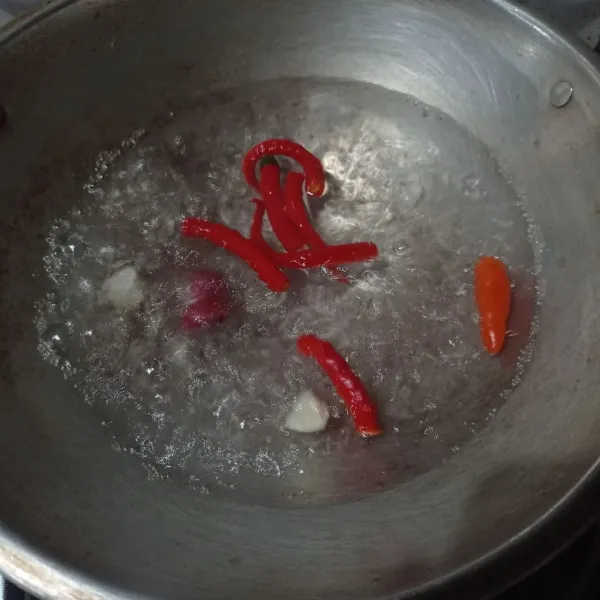 Rebus bawang merah, bawah putih, cabe sampai matang, tiriskan.