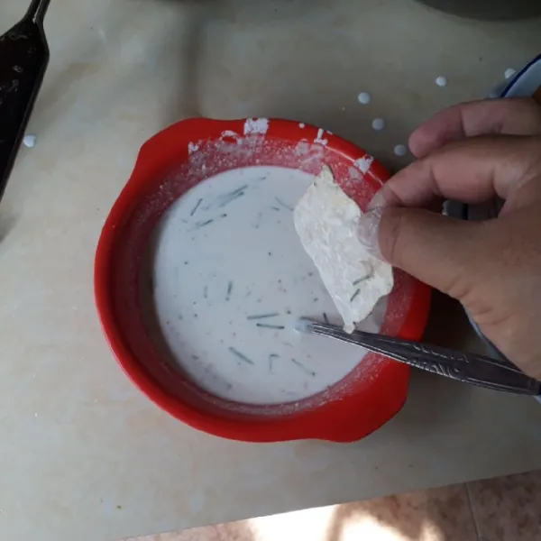 Celupkan tempe satu demi satu ke dalam adonan tepung.