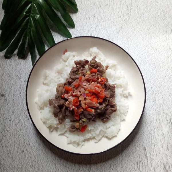 Ambil nasi di mangkok, tata beefnya lalu berikan sambal di atas beef. Siap disajikan.