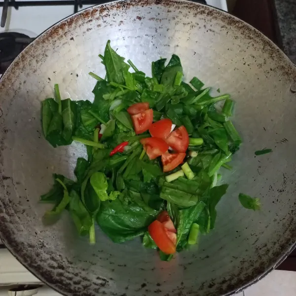 Masukkan irisan daun bawang dan tomat, aduk rata.