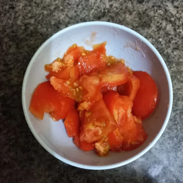 Siapkan potongan tomat, lalu hancurkan menggunakan sendok makan.