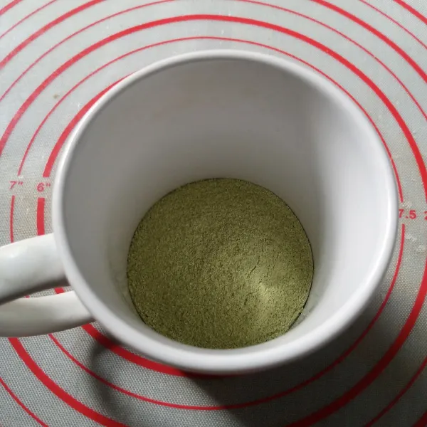 Masukkan kental manis dan bubuk matcha latte ke dalam gelas.