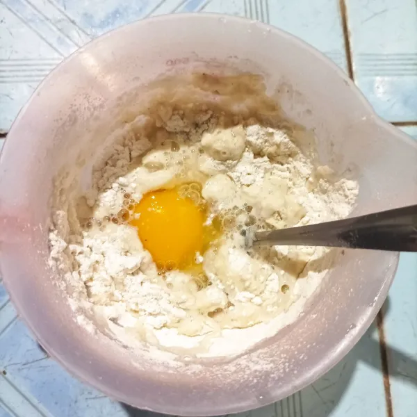 Siapkan gelas takar yang ada mulutnya agar mudah saat menuang adonan. Masukkan terigu, telur, garam, lada, dan air. Aduk hingga rata.