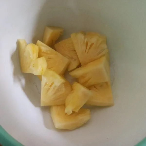 Cuci bersih nanas yang sudah dikupas kemudian potong-potong.