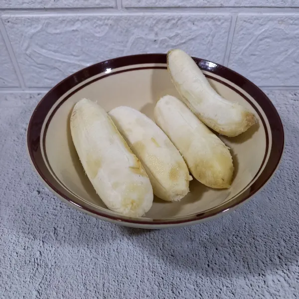 Kupas pisang dan letakkan di mangkok.