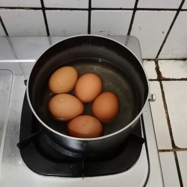 Rebus telur dengan metode 2 menit dengan api besar, 3 menit dengan api kecil, dalam keadaan panci tertutup. Diamkan selama 10 menit, jangan buka tutup panci.