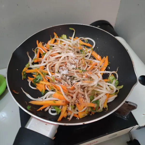 Masukkan wortel dan tauge, bumbui dengan garam, kaldu jamur dan lada bubuk, masak hingga wortel matang.