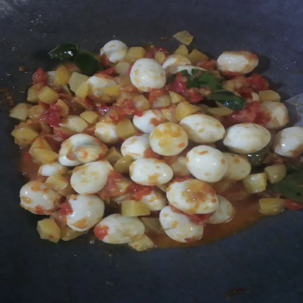 Masukkan kentang dan telur puyuh yang sudah di goreng. Beri kecap manis. Aduk rata. Masak sampai bumbu meresap dan air menyusut.