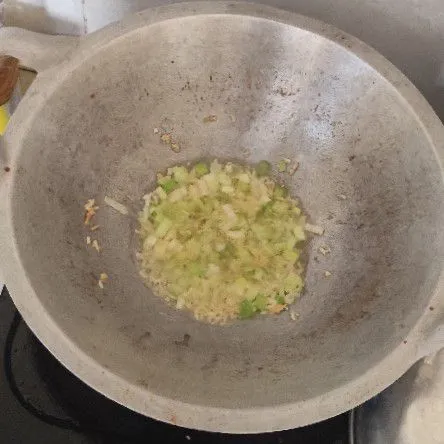 Tumis hingga layu harum parutan bawang putih dan irisan daun bawang.