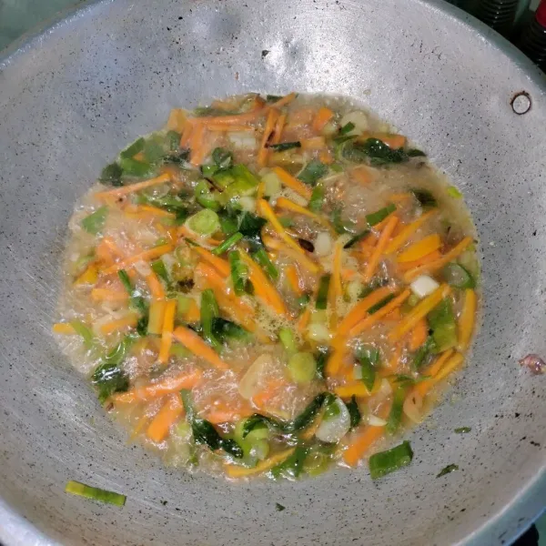 Tumis bawang merah, bawang putih dan cabai rawit hingga harum lalu masukkan wortel, masak dengan sedikit air, masak hingga wortel layu.