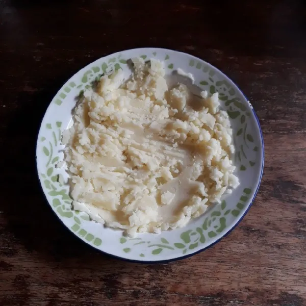Kukus atau rebus kentang hingga empuk. Selagi panas, haluskan dengan garpu.