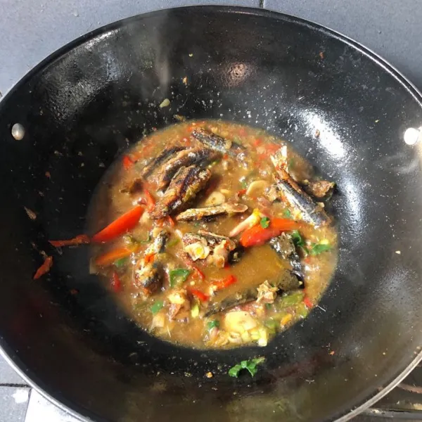 Kemudian beri air sedikit. Lalu masukan ikan asin peda yang sudah digoreng, beri 1/2 sdm kaldu bubuk, 1 sdm gula pasir, dan garam secukupnya. Lalu masukan tomat dan daun bawang, icip rasa lalu sajikan.