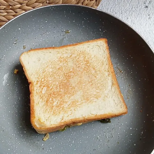 Kemudian timpa lagi dengan 1 lembar roti. Panggang hingga kecoklatan dan angkat.