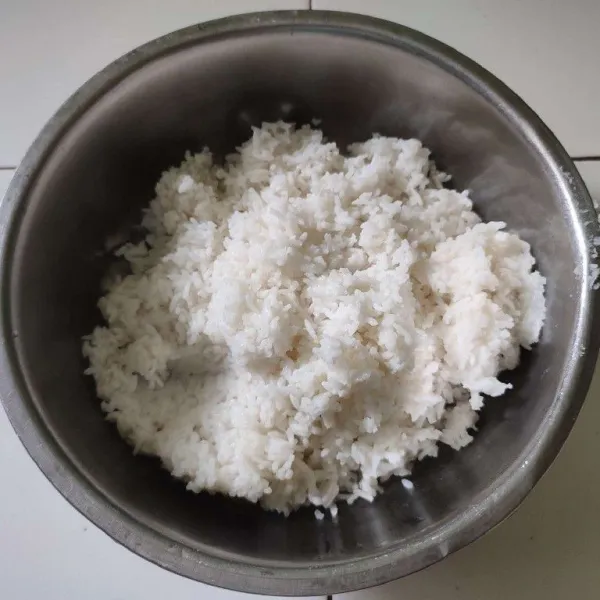 Masak nasi di rice cooker dengan takaran air yang ada, tambahkan santan dan garam. Setelah matang, keluarkan dari rice cooker. Tuang ke dalam wadah.