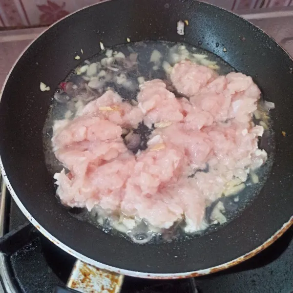 Tumis bawang merah dan bawang putih sampai harum dan matang. Setelah bumbu matang, masukkan daging ayam, lalu tambahkan air secukupnya.