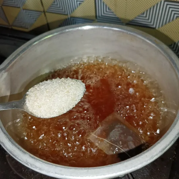 Kemudian masukkan gula pasir dan aduk-aduk sampai gula larut, biarkan sampai hangat.