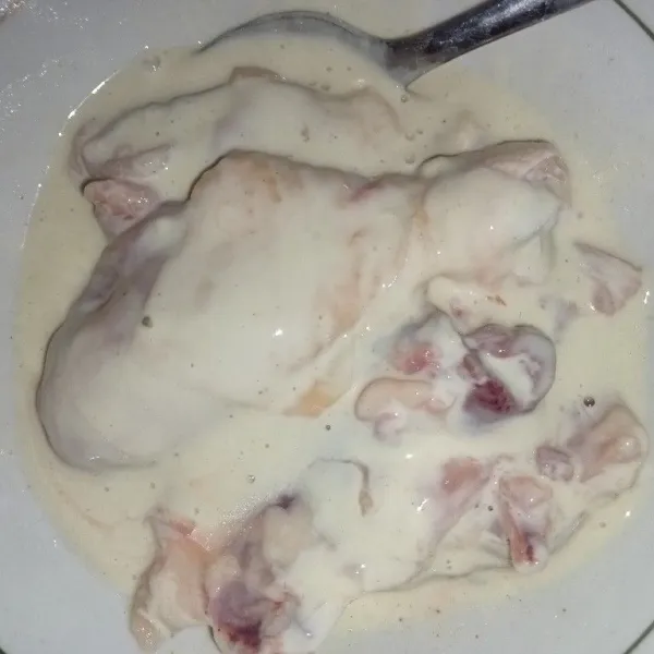 Aduk rata ayam dengan bahan basah hingga terlumuri dengan adonan.