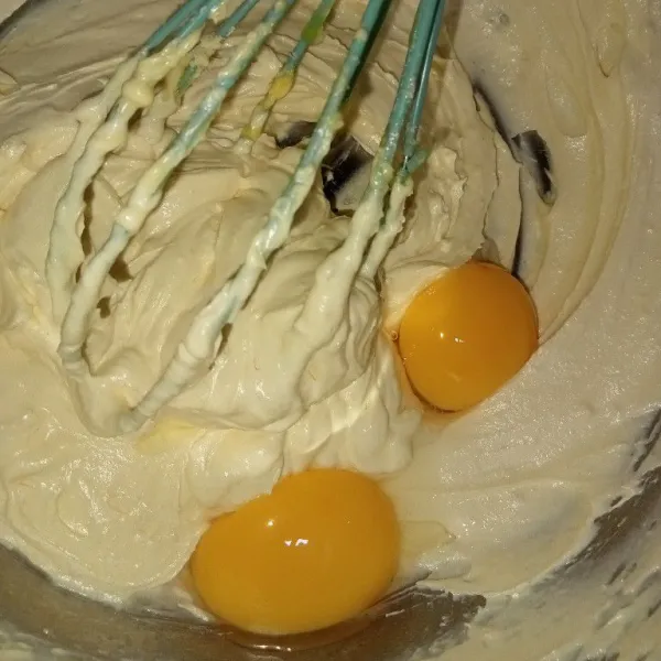 Aduk menggunakan balon whisk margarin, butter, dan gula sampai mengembang putih, masukkan telur aduk rata.