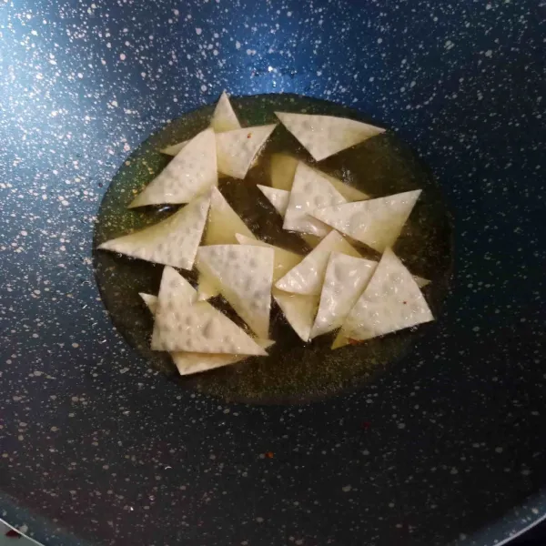 Potong kerupuk pangsit sesuai selera. Goreng hingga matang.