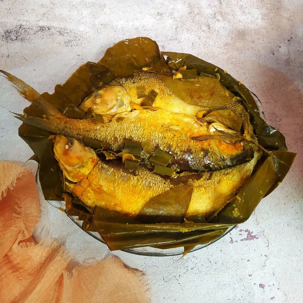 Bandeng Presto being fried in a traditional Indonesian kitchen