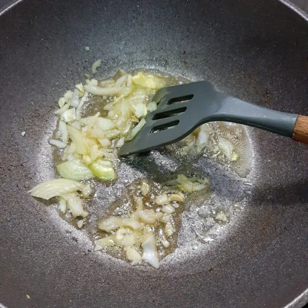 Dalam wajan lain, tumis bawang bombay dan bawang putih dengan butter.