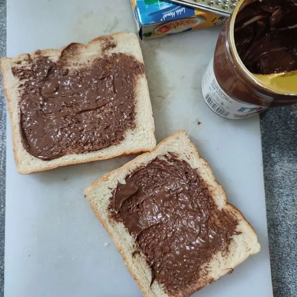 Oles roti dengan selai nutella.