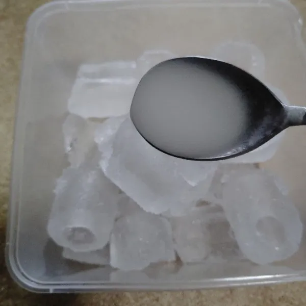 Siapkan es batu dalam wadah lalu tuang jelly yang panas dan sendok sedikit demi sedikit.