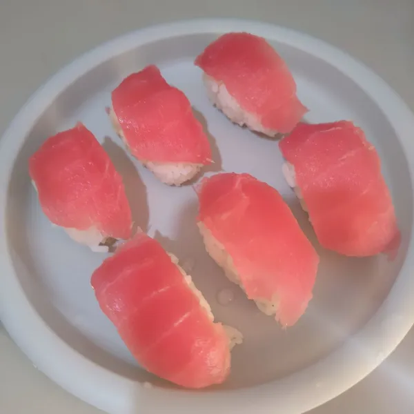 Tata irisan ikan tuna di atas nasi.