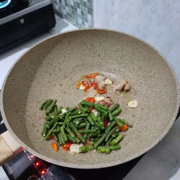 Masukkan kacang panjang, aduk rata, lalu tumis sebentar.