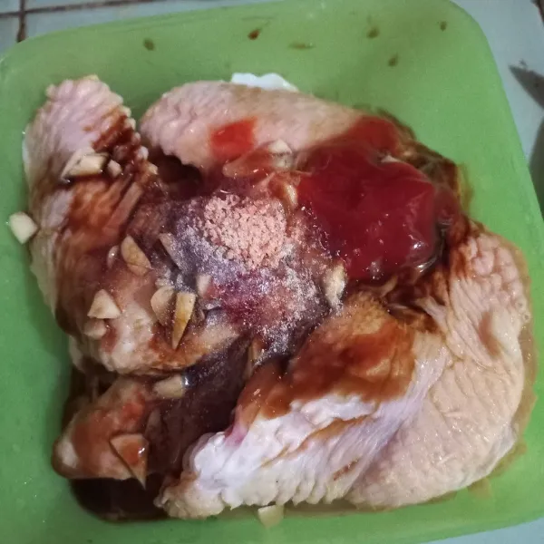 Cincang bawang putih, kemudian masukkan ke wadah berisi ayam bersama sisa bumbu lainnya.