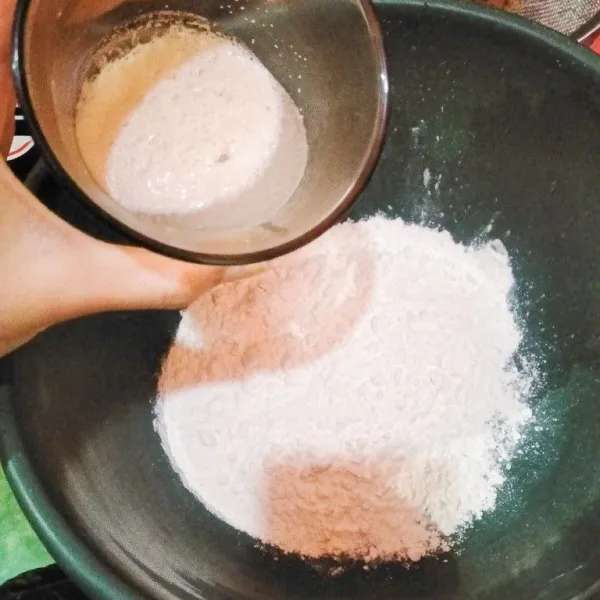 Masukkan ragi yang telah aktif ke dalam tepung terigu dan garam, lalu uleni sampai kalis.