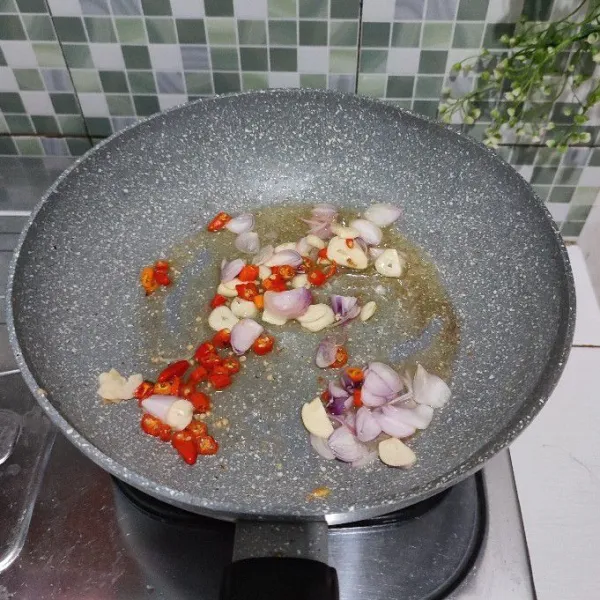 Panaskan minyak goreng, masukkan bumbu iris, tumis hingga wangi dan berubah warna.